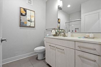 A white bathroom with a toilet and a sink